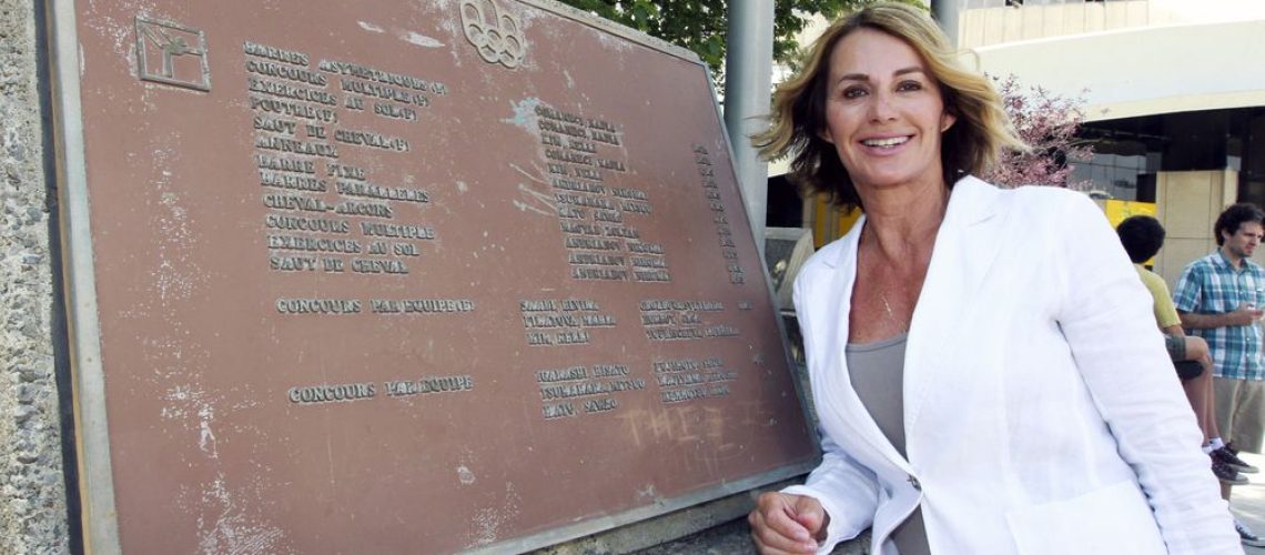 MONTREAL, QUE.: JULY 21, 2016 -- Nadia Comaneci poses for photos with a plaque at Olympic Park in Montreal Thursday July 21, 2016 detailing the winners in gymnastics at the 1976 Olympic Summer Games that here held in Montreal.  Comaneci was in Montreal to mark the 40th anniversary of the Games.  (John Mahoney} / MONTREAL GAZETTE) ORG XMIT: 56717 - 3907